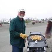 old man grilling food
